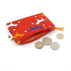 Red dog print purse with orange lining and coins