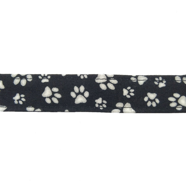 Black fabric lanyard with white paw prints close up