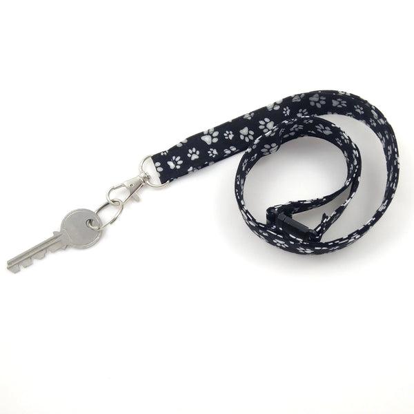 Black fabric key holder with white paw prints