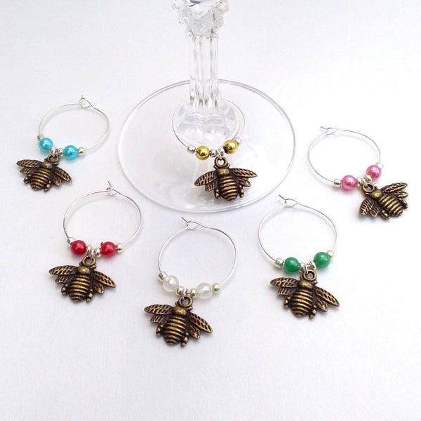 Set of 6 bronze coloured bees wine charms