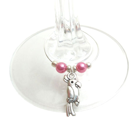 Parrot wine glass charm attached to the stem of a wine glass