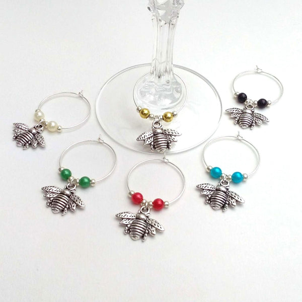 Set of 6 silver coloured metal bee wine charms