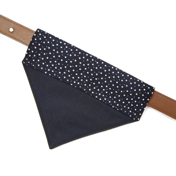 Back of lined black with tiny white stars dog bandana on collar from above
