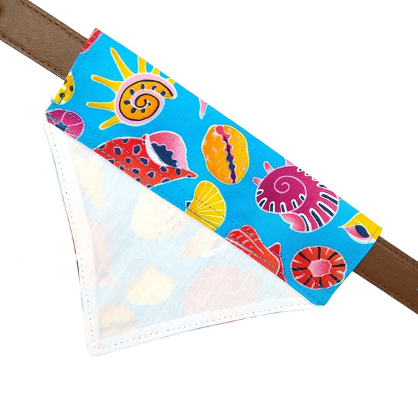 Blue dog bandana with yellow, orange, pink and red shell print on collar