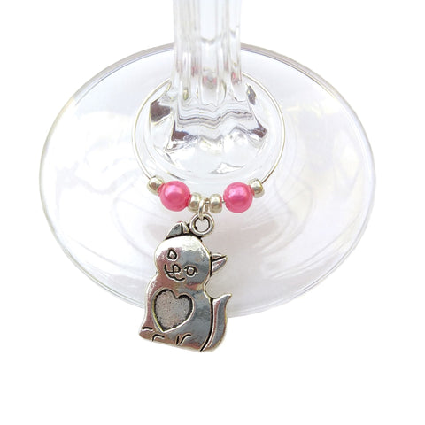 Cat wine glass charm clipped onto stem of wine glass
