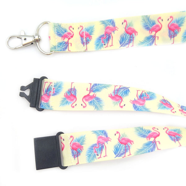 Close up of cream flamingo lanyard with metal swivel clasp and black safety buckle