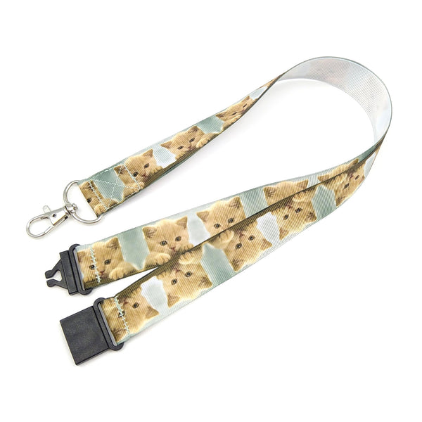 Lanyard featuring a row of kittens against a jade background