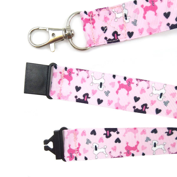 Close up of pink poodle lanyard with metal swivel clasp and black plastic safety buckle