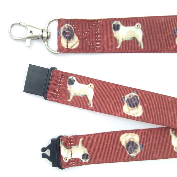 Close up of maroon pug lanyard with metal swivel clasp and black safety buckle