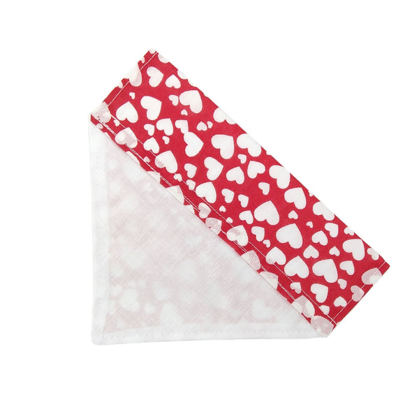 Back of red with white hearts lined dog bandana from above
