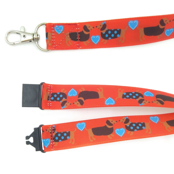 Close up a red dachshund lanyard with metal swivel clasp and black safety buckle
