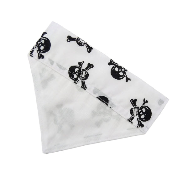 white dog bandana printed with black skulls and a white lining